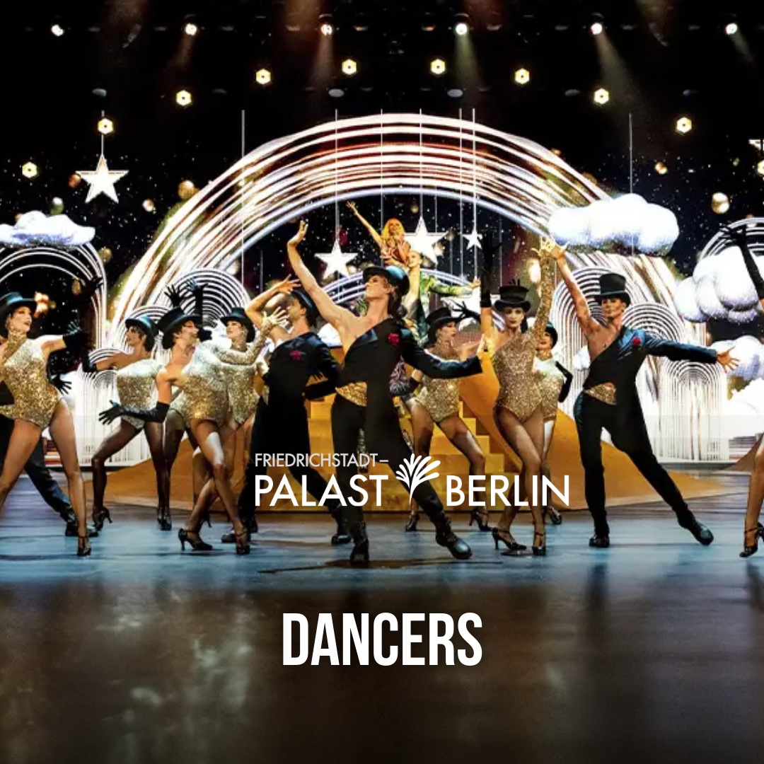 The Friedrichstadt-Palast company spread across the stage in gold costumes and black tails during a full-company number