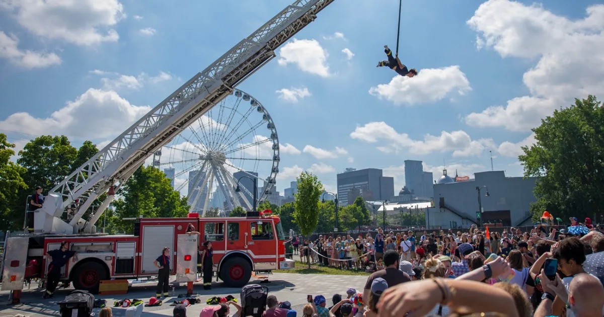 A red fire truck converted into a mobile circus performance stage