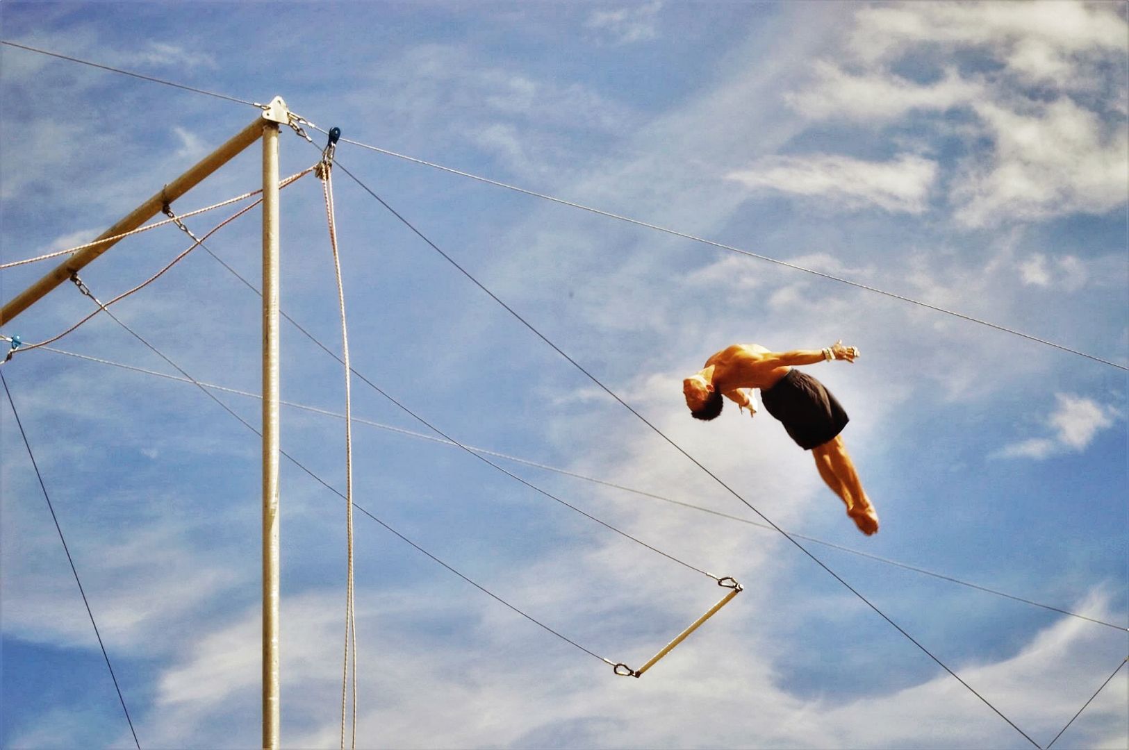Flying trapeze artist mid-catch