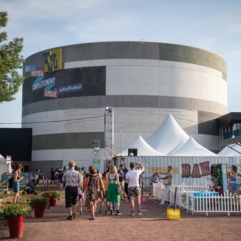 TOHU's circular venue in Montreal, with festival signage and visitors outside